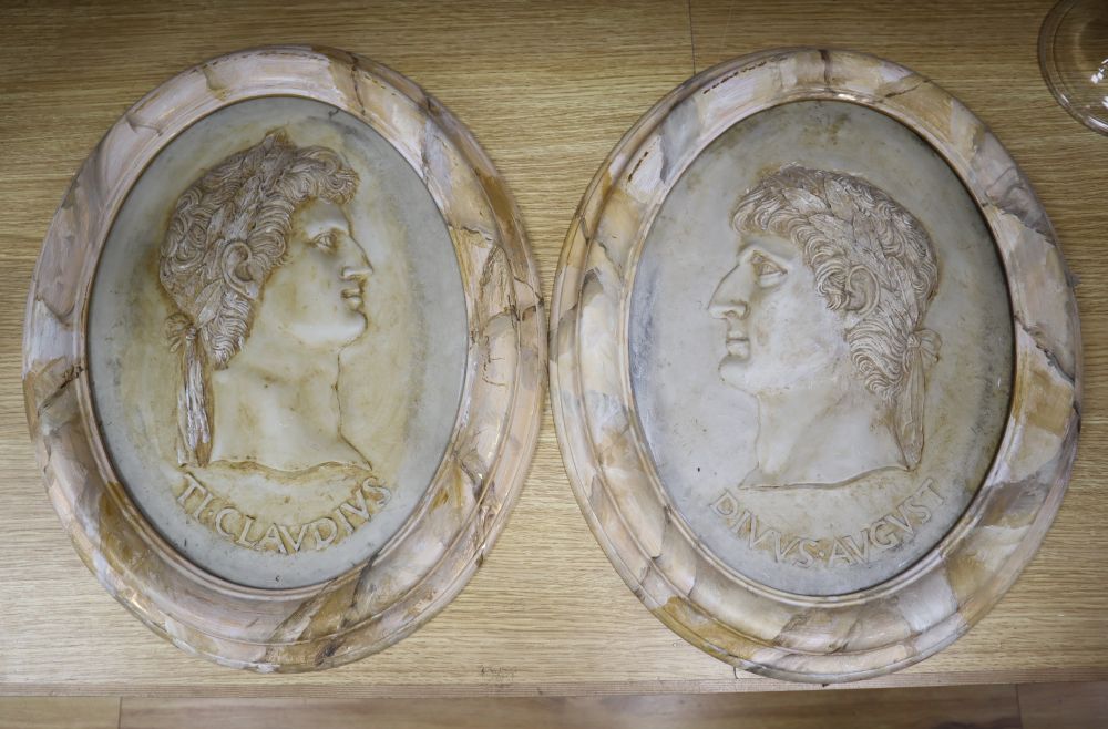 A pair of painted resin Claudius plaques, height 38cm